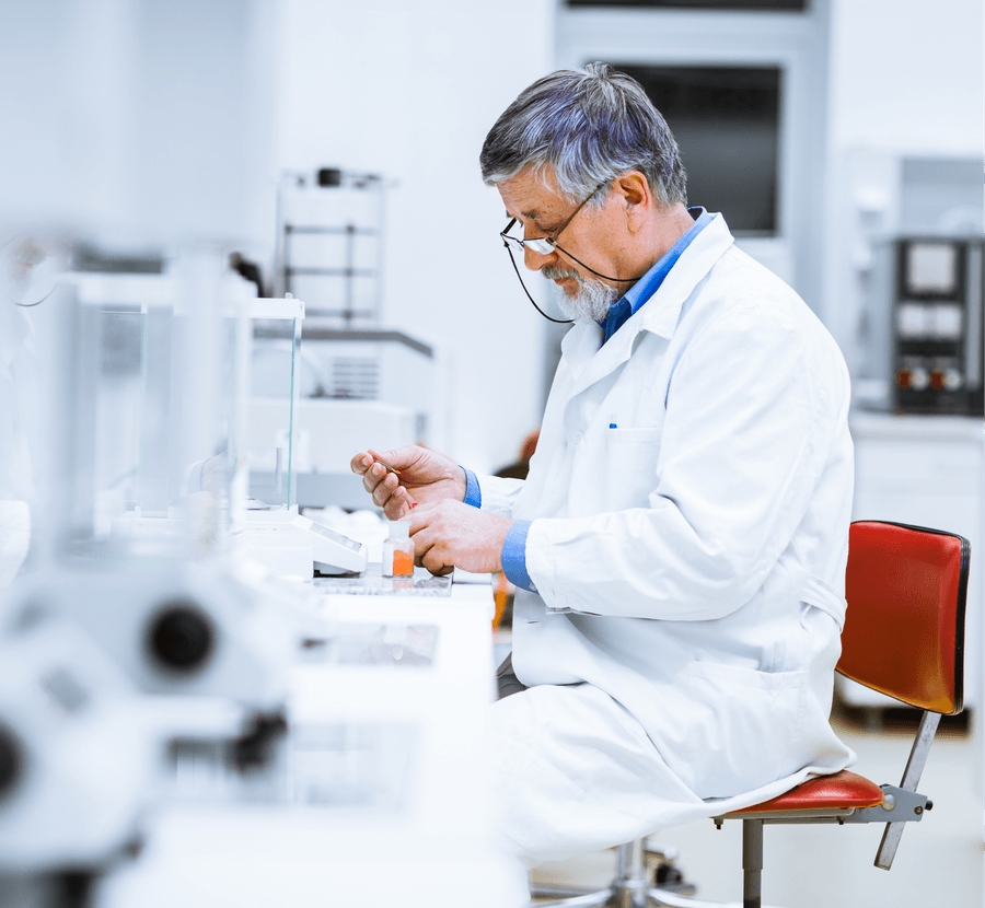 A researcher weighing a sample at a laboratory bench