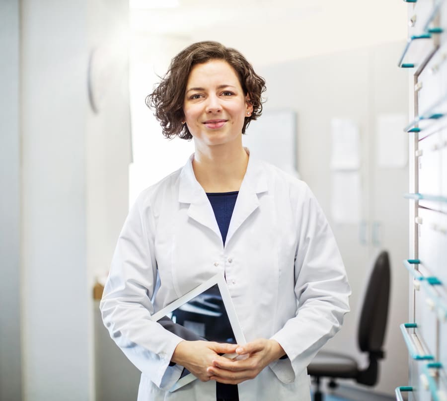 A pharmacist holding a tablet in the dispensary