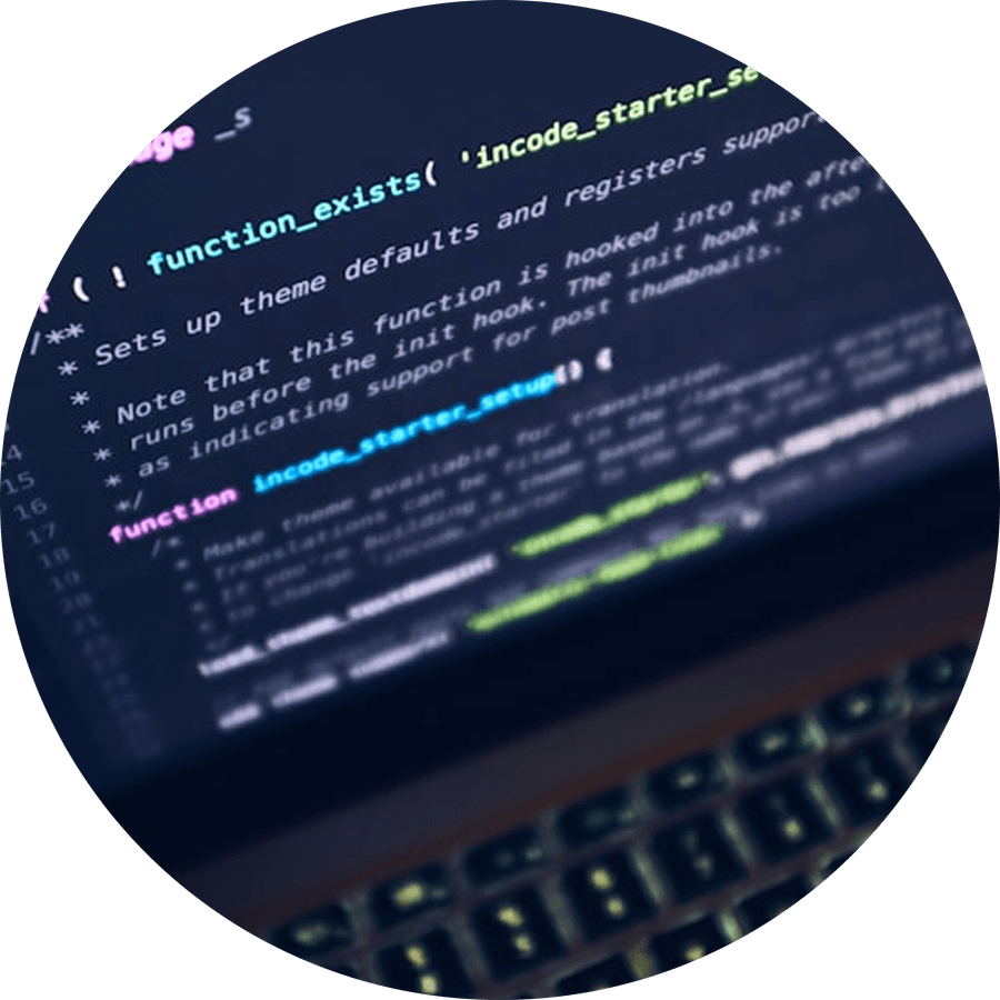 Source code on screen above a keyboard