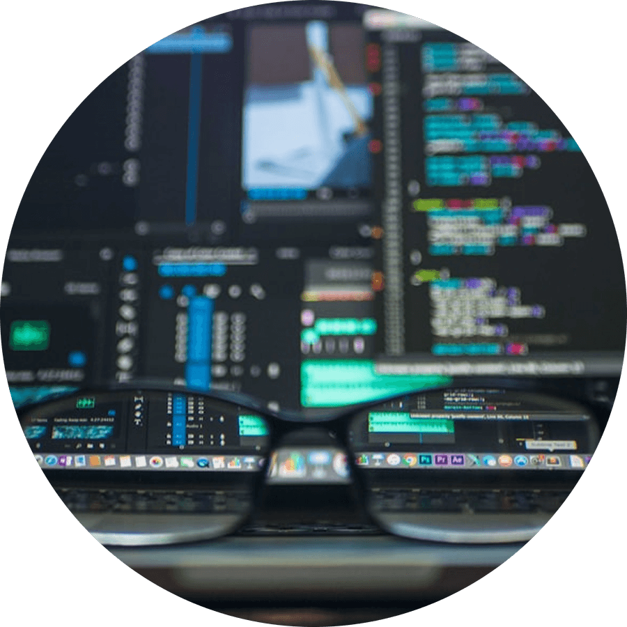 Glasses in front of a monitor of code