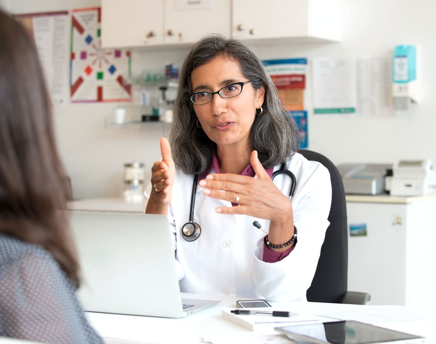 A pharmacist talking through findings on a video call