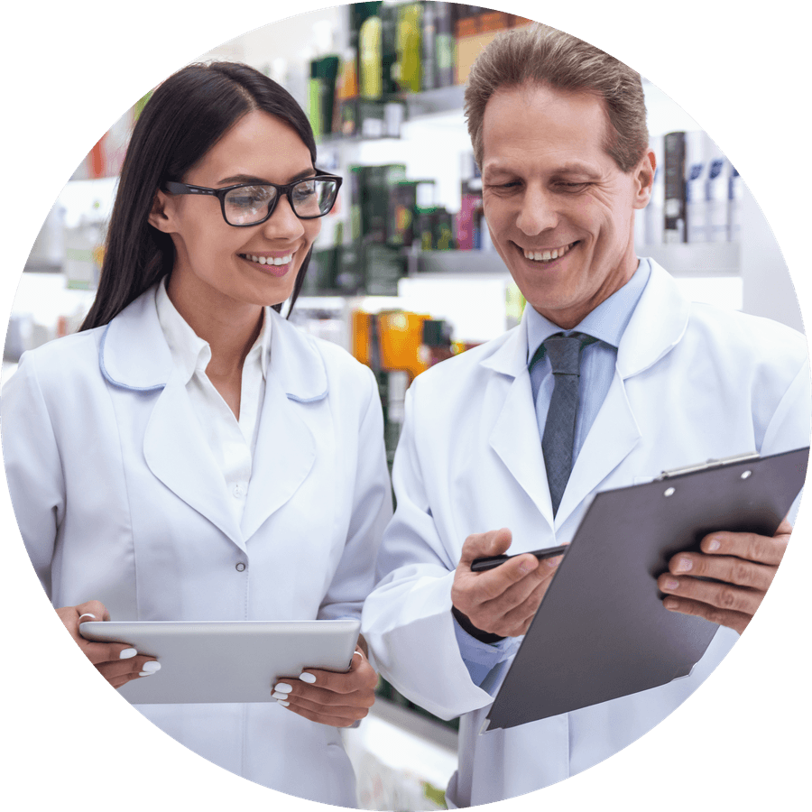 Two pharmacists going through an opening checklist in front of stocked shelves