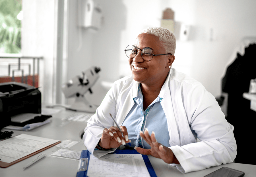 A pharmacist at a desk of paperwork