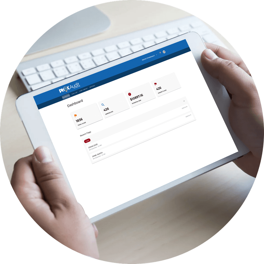 A pharmacist holding a tablet showing the PhoxAudit dashboard