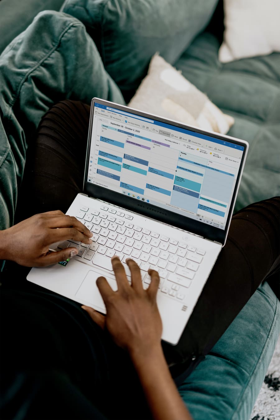 Someone working through an appointment calendar on a laptop