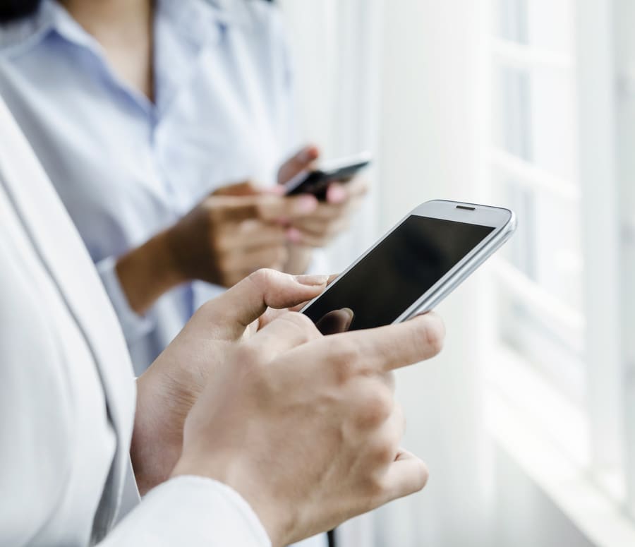 A pharmacist reading a message on a phone