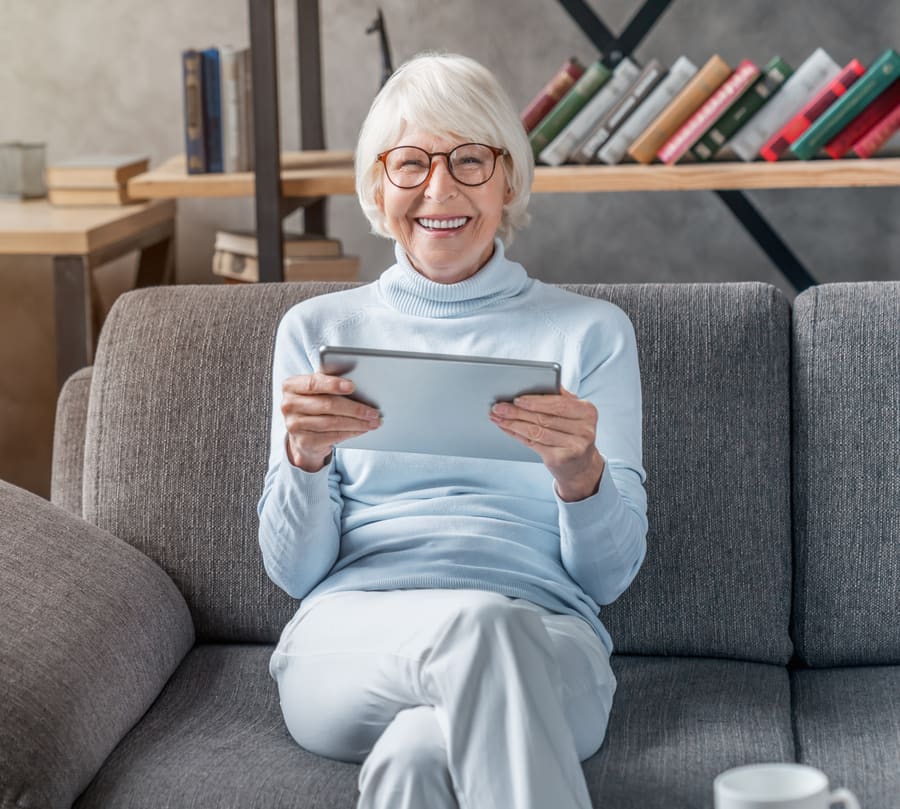 A patient paying on a tablet at home