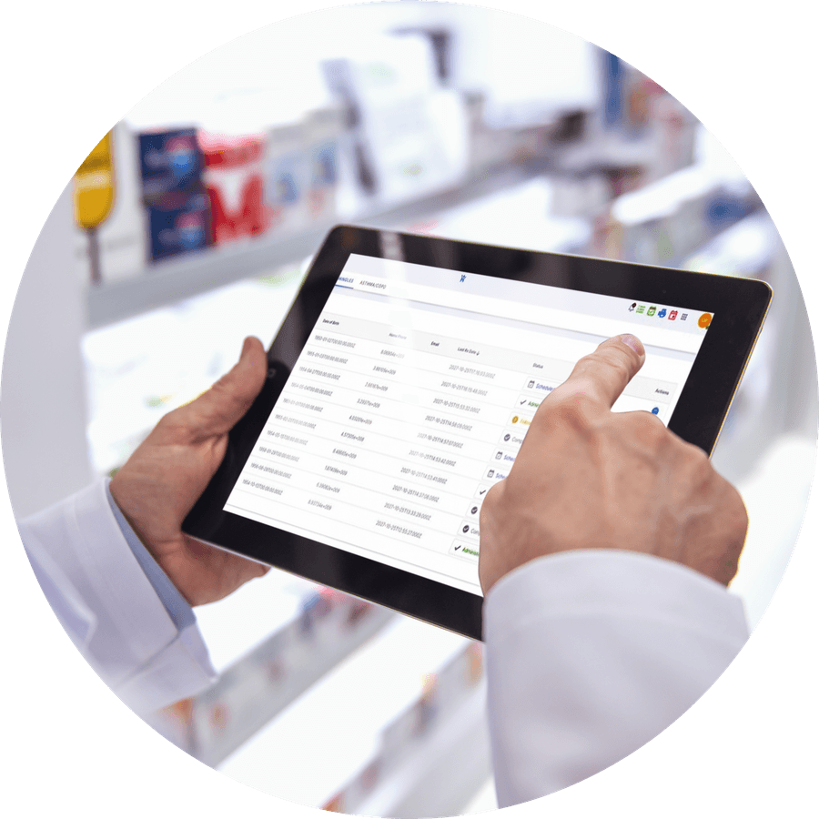 A pharmacist reviewing a patient list on a tablet