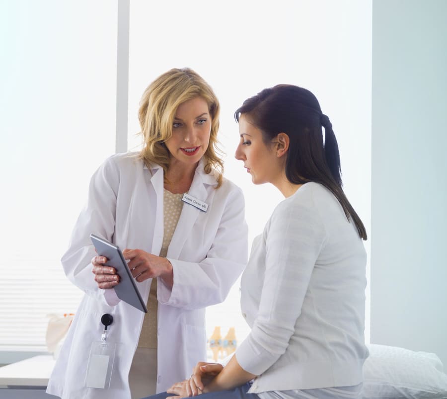 A pharmacist and a patient going over the patient's medications together