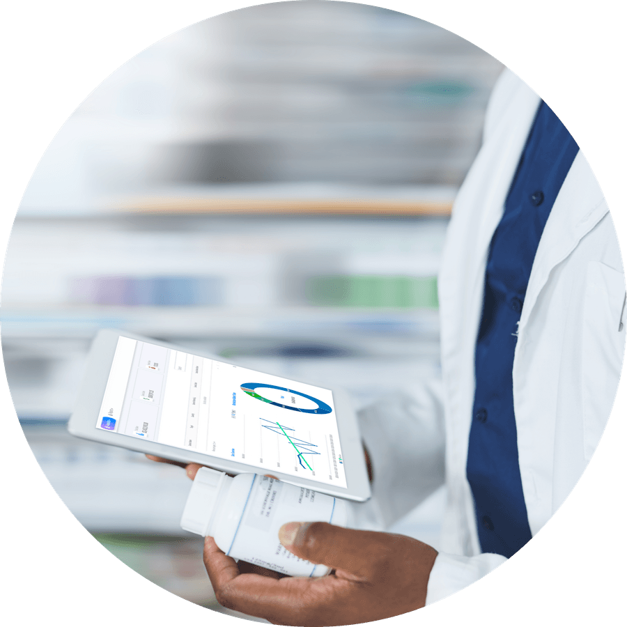 A pharmacist checking a product's numbers on a tablet